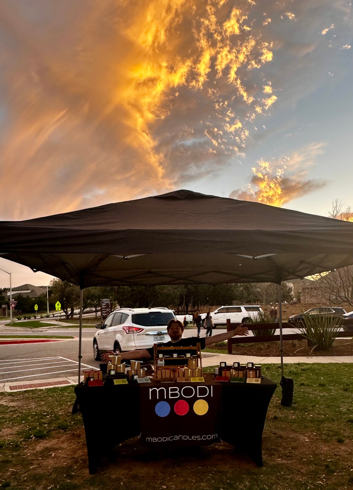 Wide shot of Mbodi tent setup at a local market event