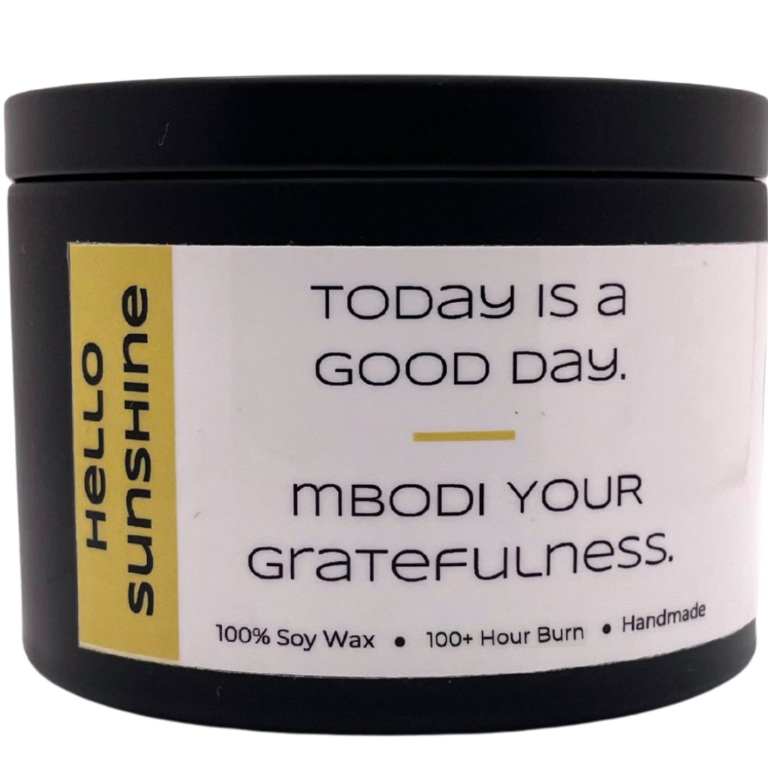 Mbodi 15 oz soy candle ‘Hello Sunshine’ in metal tin with bright yellow label designed for a bright, uplifting, and warm atmosphere
