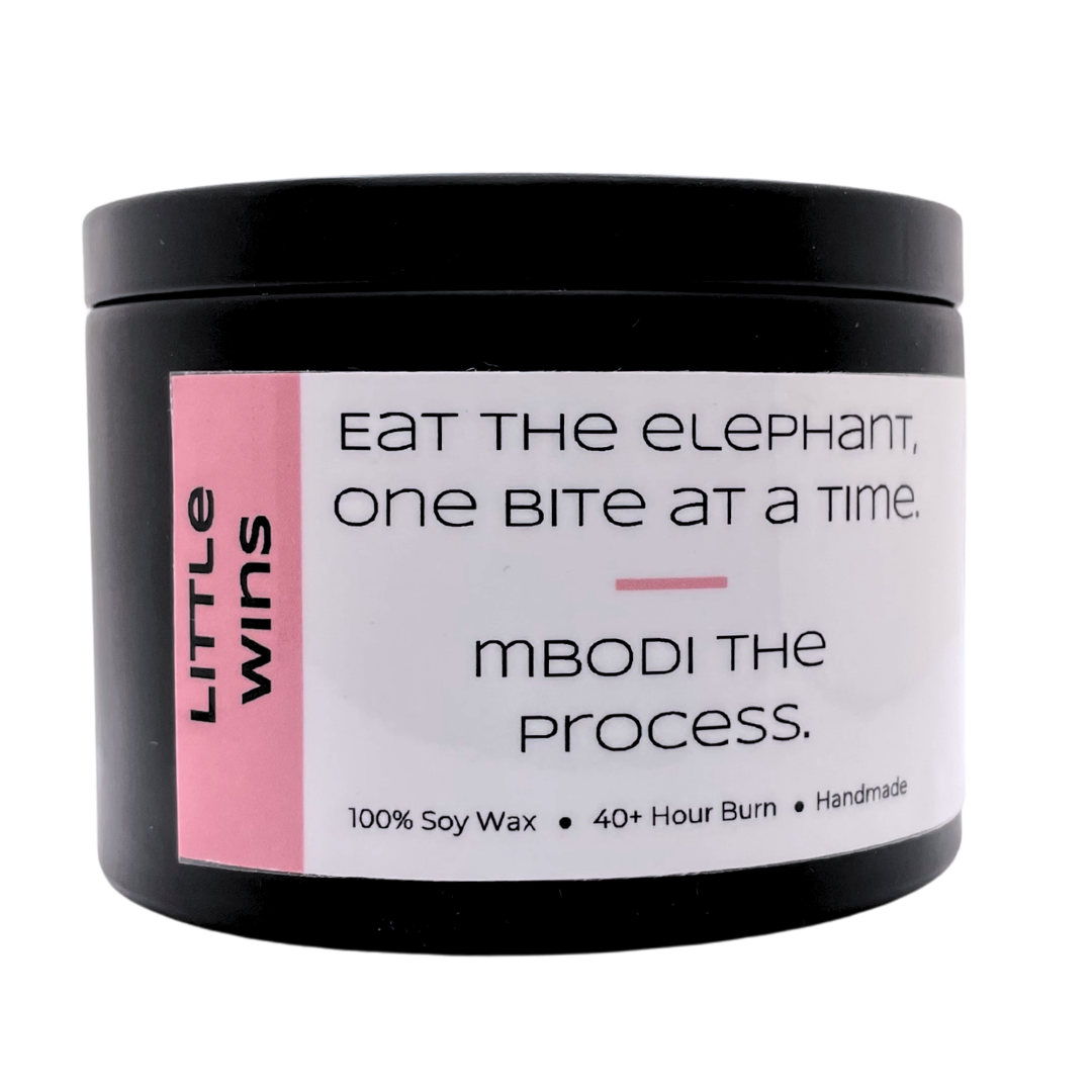 Mbodi 6 oz soy candle ‘Little Wins’ in metal tin with soft toned pink label designed to celebrate small moments of progress and motivation