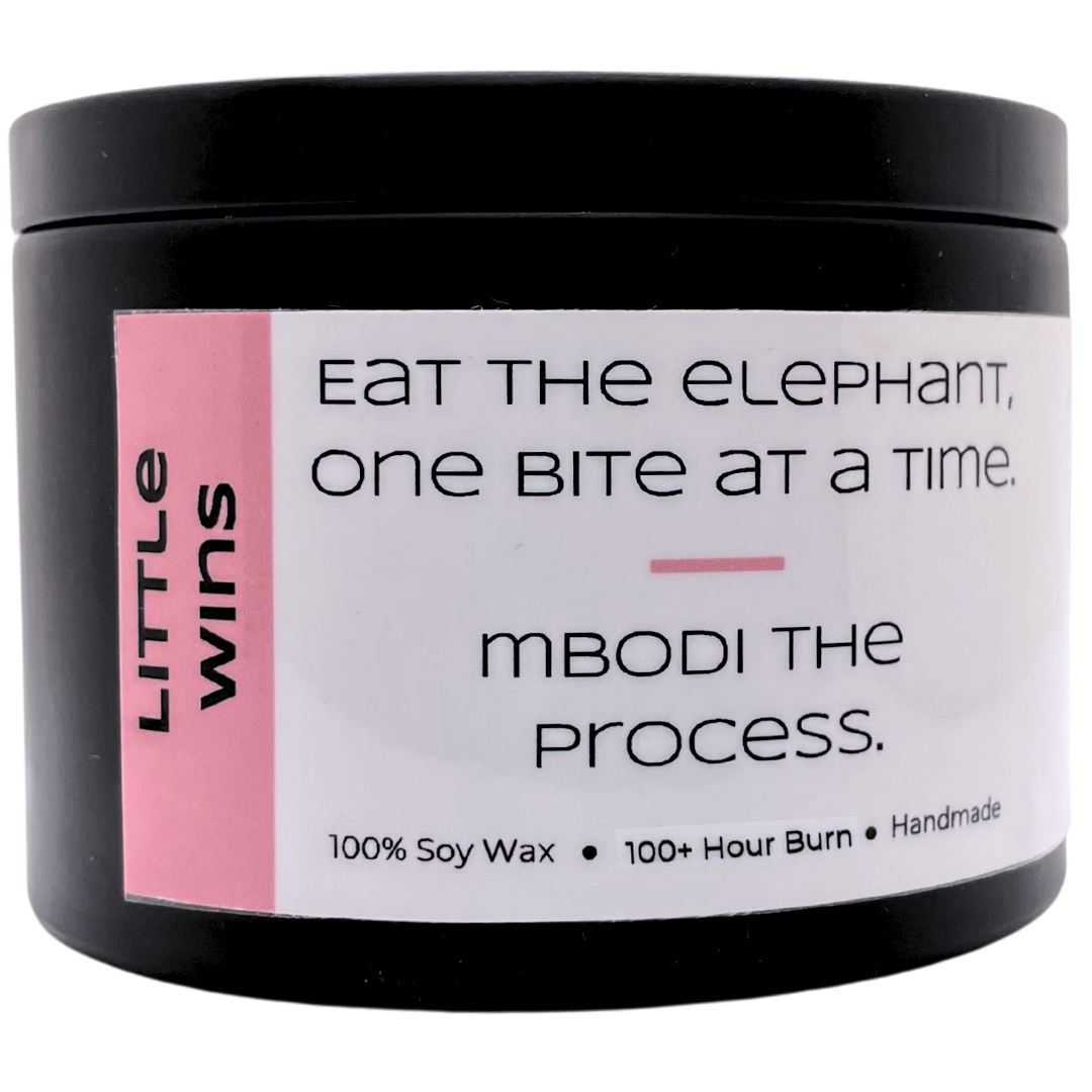 Mbodi 15 oz soy candle ‘Little Wins’ in metal tin with soft toned pink label designed to celebrate small moments of progress and motivation