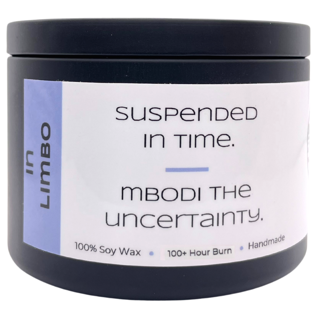 Mbodi 15 oz soy candle ‘In Limbo’ in metal tin with soft toned light blue label designed for a reflective, in between atmosphere