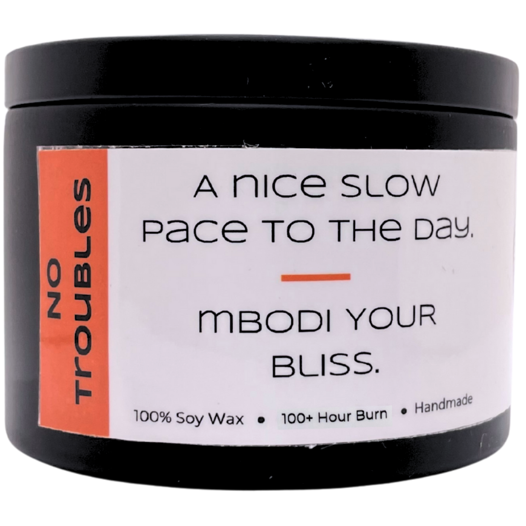 Mbodi 15 oz soy candle ‘No Troubles’ in metal tin with orange label designed for a calm, stress free atmosphere