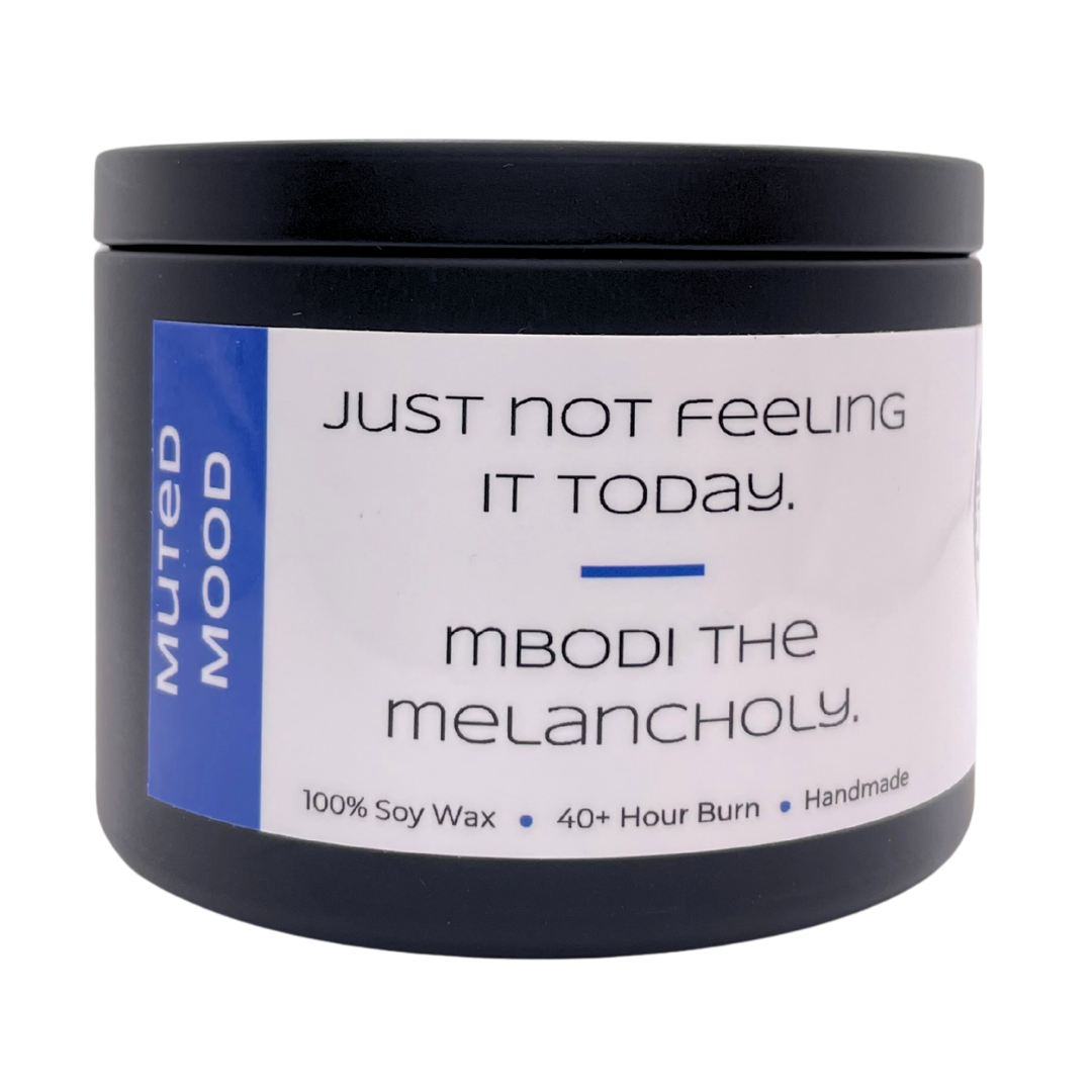 Mbodi 6 oz soy candle ‘Muted Mood’ in metal tin with blue label, crafted for a gentle, low energy, introspective environment