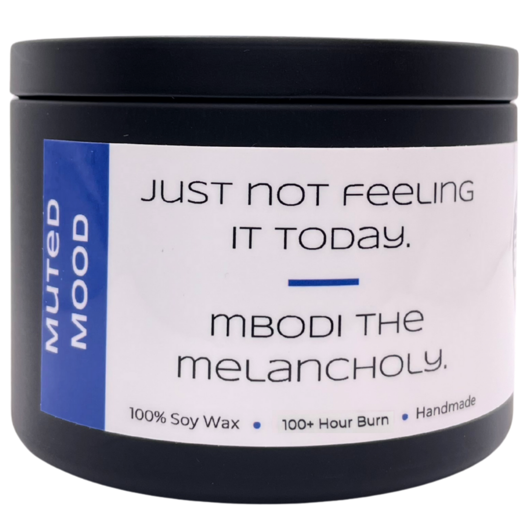 Mbodi 15 oz soy candle ‘Muted Mood’ in metal tin with blue label, crafted for a gentle, low energy, introspective environment
