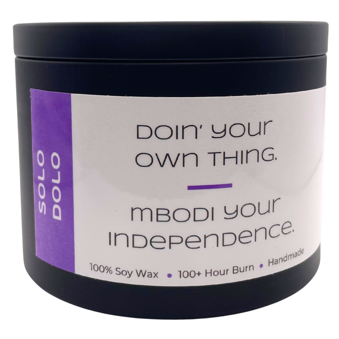Mbodi 15 oz soy candle ‘Solo Dolo’ in metal tin with Purple label designed for independence and self reflection