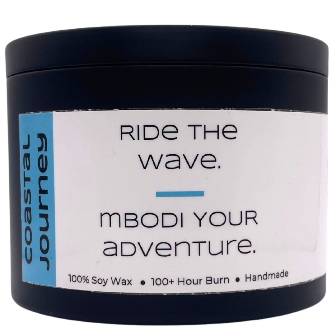 Mbodi 15 oz soy candle ‘Coastal Journey’ in metal tin with minimal beach blue label, crafted for a breezy, open, and restorative environment inspired by the coast