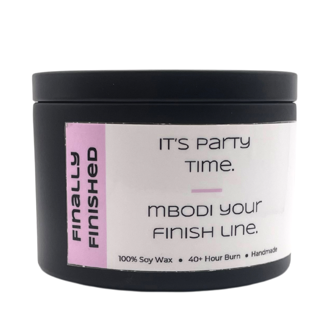 Mbodi 6 oz soy candle ‘Finally Finished’ in metal tin with soft toned pink label designed for celebrating, partying, and enjoying the weekend