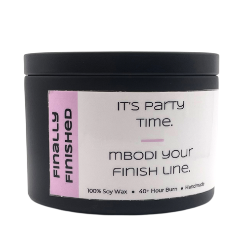 Mbodi 6 oz soy candle ‘Finally Finished’ in metal tin with soft toned pink label designed for celebrating, partying, and enjoying the weekend