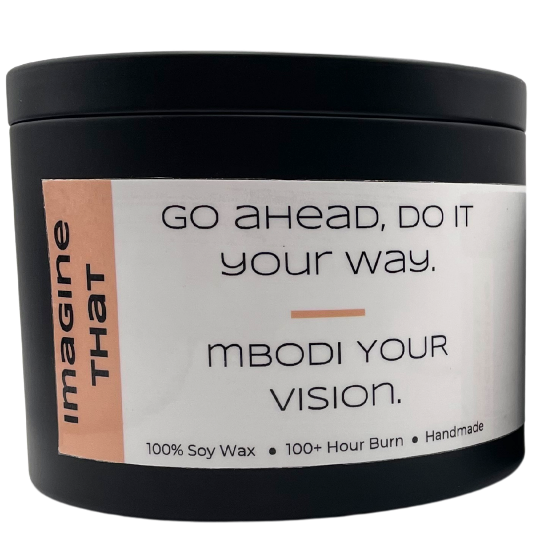 Mbodi 15 oz soy candle ‘Imagine That’ in metal tin with soft toned peach label designed for creativity, curiosity, and open minded thinking