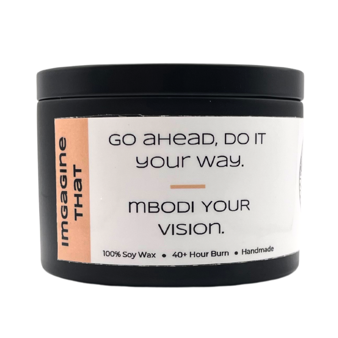 Mbodi 6 oz soy candle ‘Imagine That’ in metal tin with soft toned peach label designed for creativity, curiosity, and open minded thinking