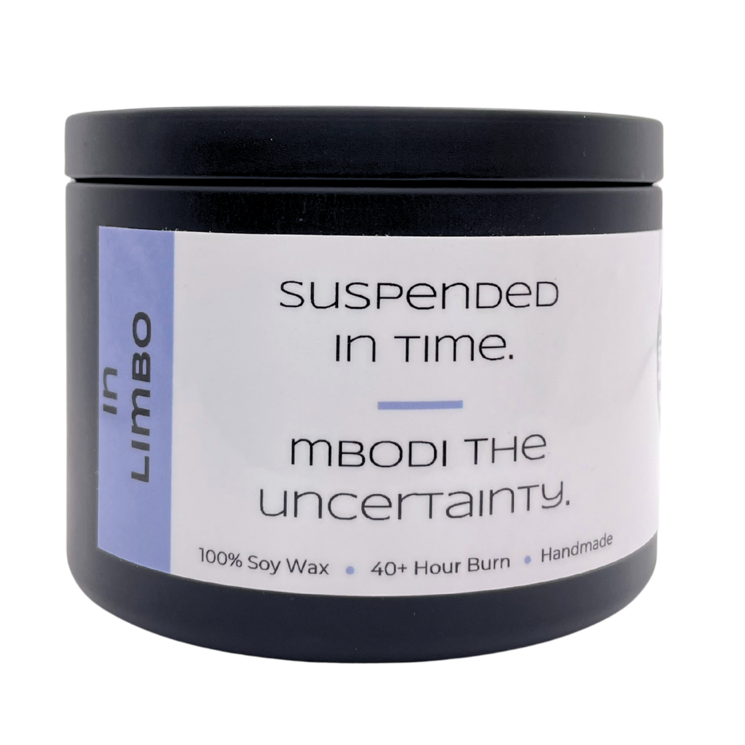 Mbodi 6 oz soy candle ‘In Limbo’ in metal tin with soft toned light blue label designed for a reflective, in between atmosphere