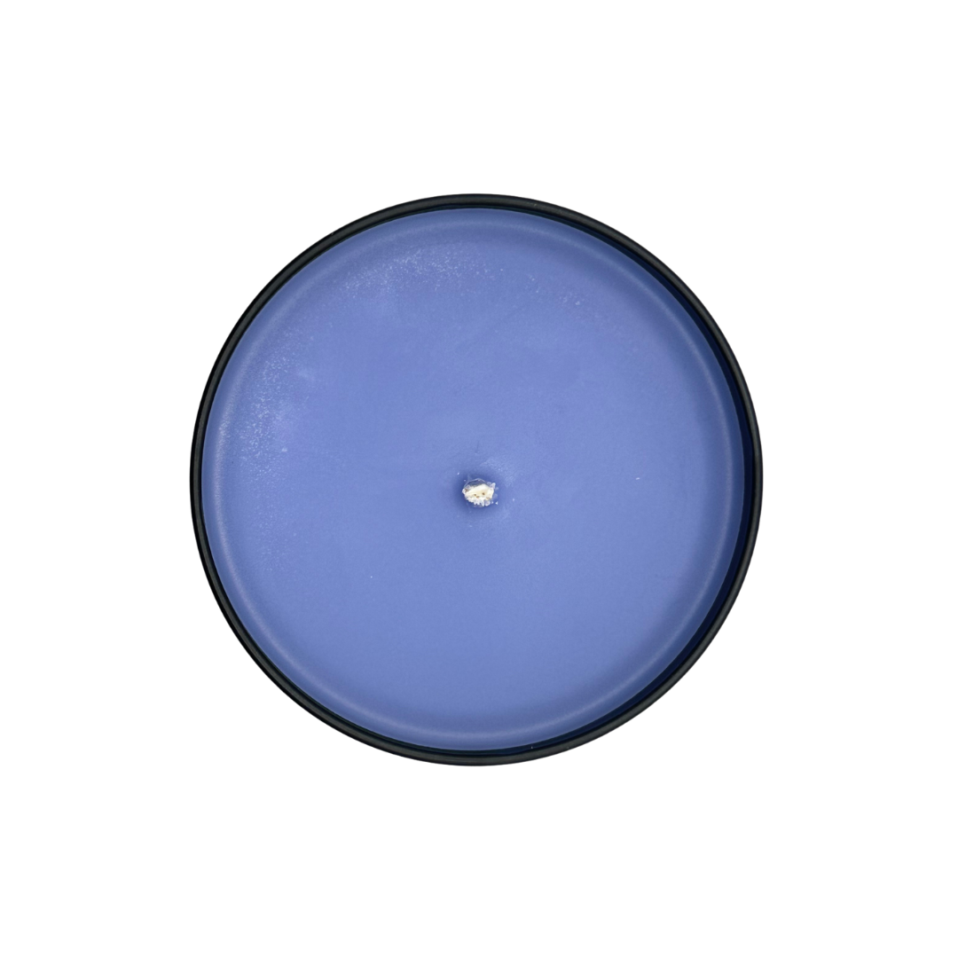 Top photo of purple soy wax Turn Up candle that smells like Bergamot, white copal, and amber.