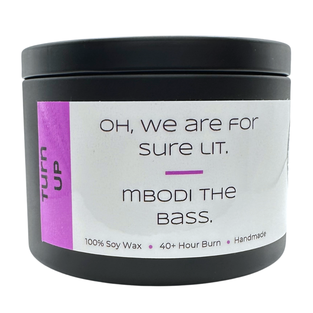 Turn Up candle with orange zest and clementine with text that says "Oh, we are for sure lit. Mbodi the bass".