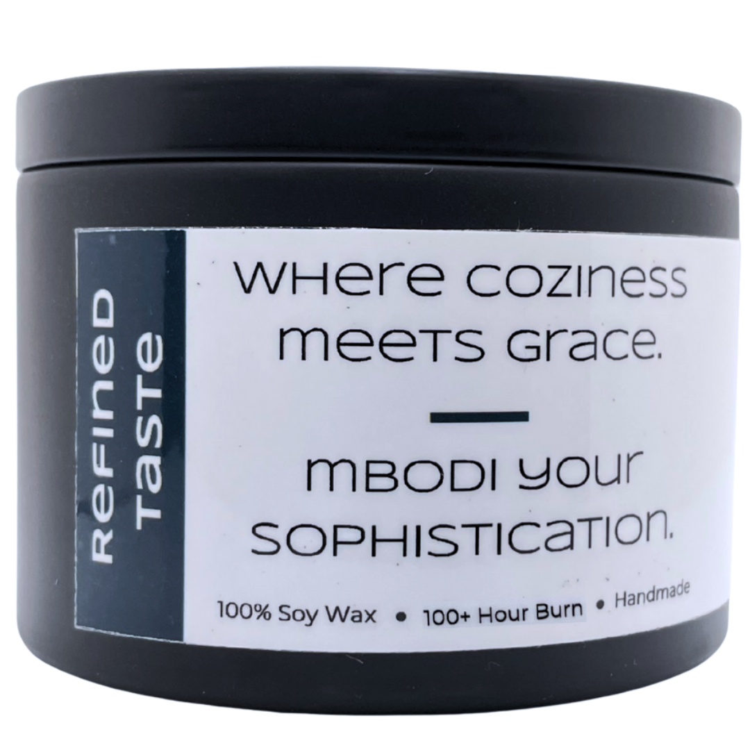 Mbodi 15 oz soy candle ‘Refined Taste’ in metal tin with navy blue label designed for a smooth, elevated atmosphere