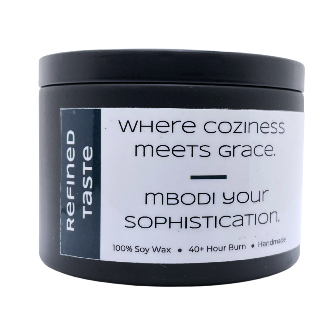 Mbodi 6 oz soy candle ‘Refined Taste’ in metal tin with navy blue label designed for a smooth, elevated atmosphere